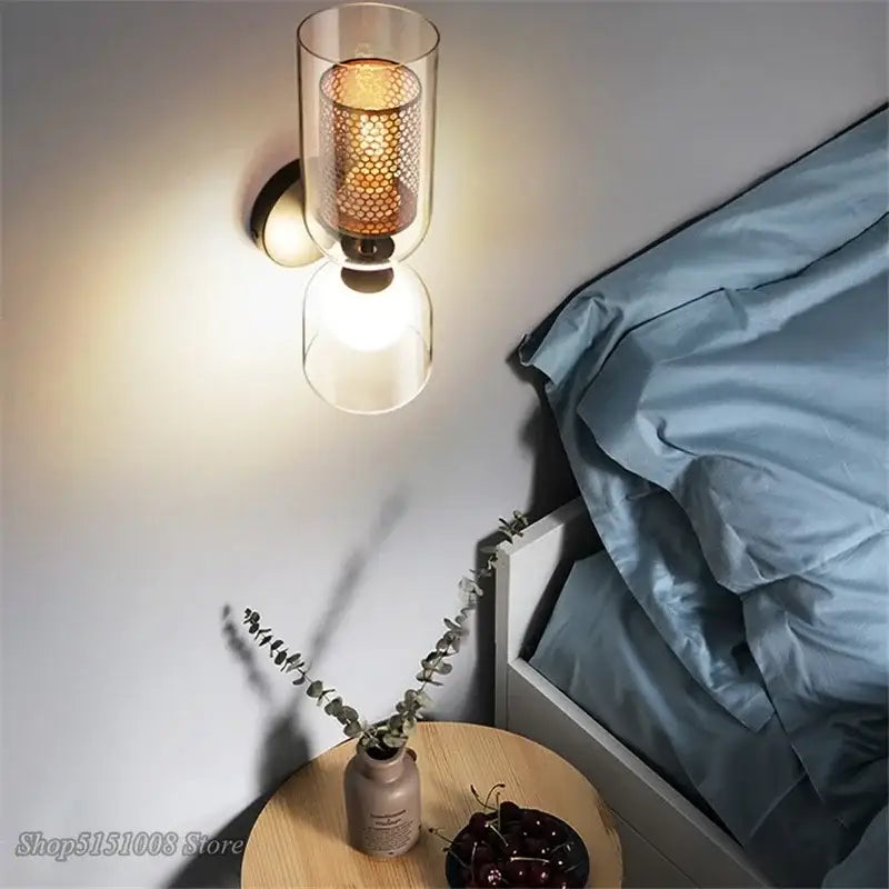 Modern glass wall lamp featuring a double head iron net frame with honeycomb mesh shade and frosted glass diffuser