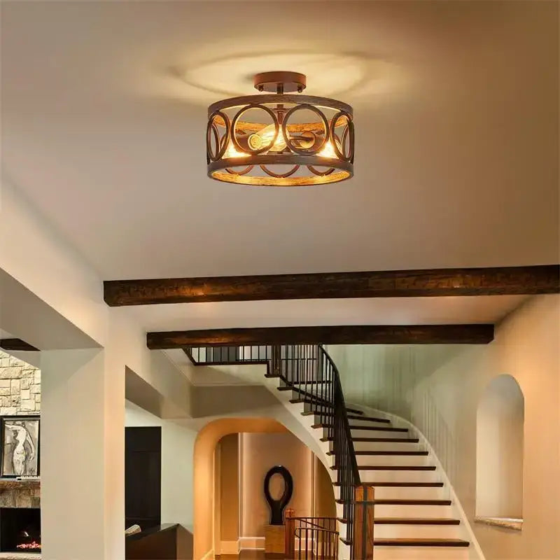 A rustic bronze industrial farmhouse chandelier with an ornate circular metal frame and exposed bulb for dining room decorbites industrial farmhouse