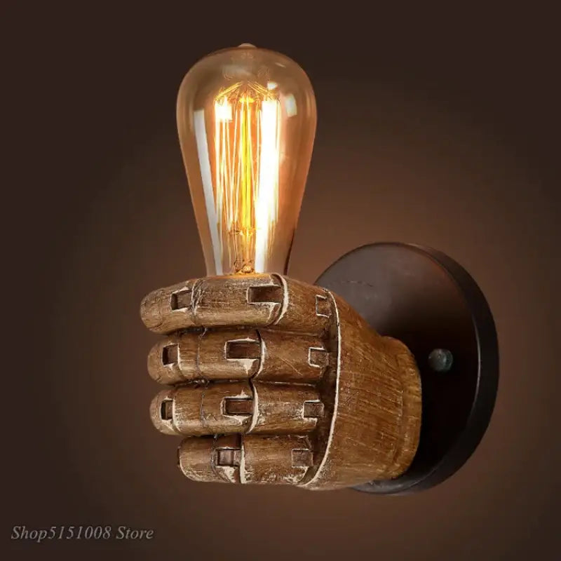 A rustic wooden industrial fist resin wall lamp with glowing amber filament bulb for vintage bedroom decorbites sconce