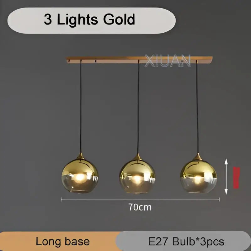 Gold-colored industrial glass pendant light with three spherical brass bulbs hanging from a wooden bar for kitchen decorbites industrial glass