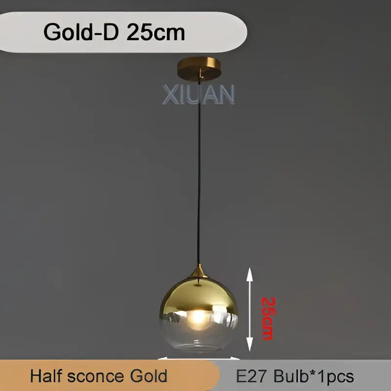 Gold-colored spherical pendant light with clear glass globe and black cord decorbites industrial glass pendant