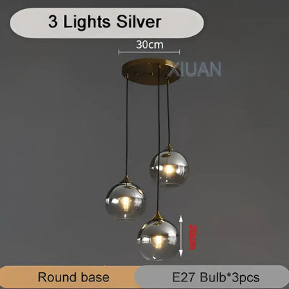 Silver three-light industrial glass pendant light with round glass globe shades and brass-finished base for kitchen decorbites industrial glass pendant