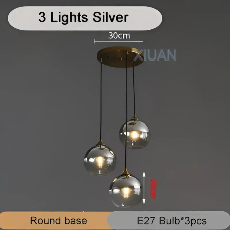 Silver three-light industrial glass pendant light with round glass globe shades and brass-finished base for kitchen decorbites industrial glass pendant