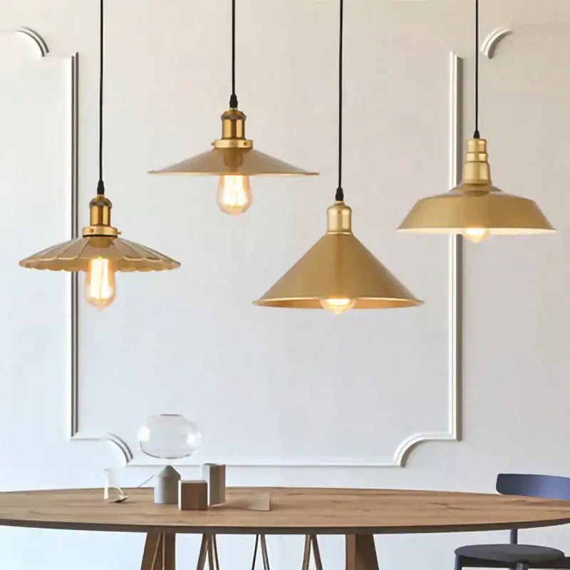 Three brass pendant lights with conical shades and exposed filament bulbs in gold wrought iron decorbites pendant light