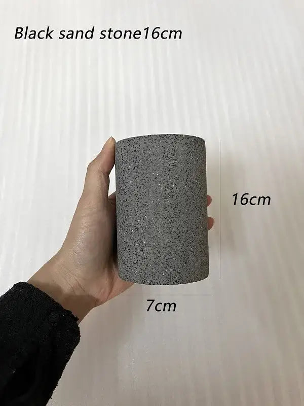 A cylindrical 16cm tall black sandstone planter with textured surface paired with decorbites industrial led ceiling light 3 pack