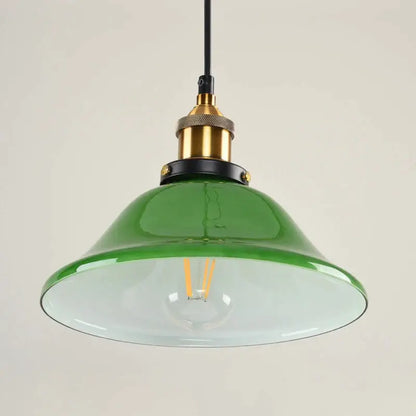 Industrial green glass pendant light with brass and black metal accents for dining room use