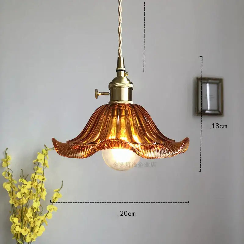 A warm amber glass industrial pendant light with fluted petal design and brass hardware for dining room decorbites glass industrial