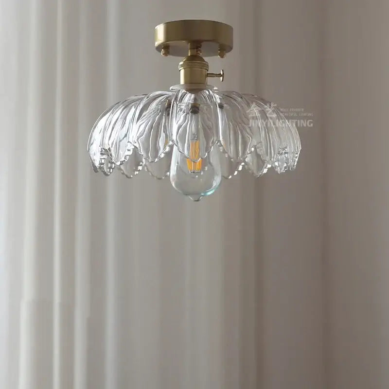 Clear leaf-shaped glass industrial pendant light with brass mount and exposed filament bulb for dining room decorbites glass industrial
