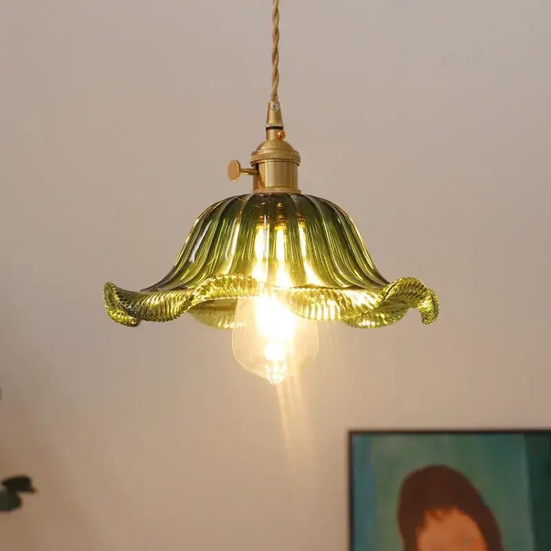 A warm glowing green glass industrial pendant light with brass fixture and twisted cord for dining room decorbites glass industrial