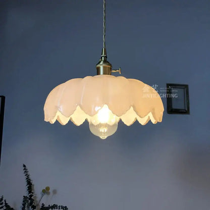 Cream-colored petal glass industrial pendant light with brass fixture and exposed bulb for dining room decorbites glass industrial