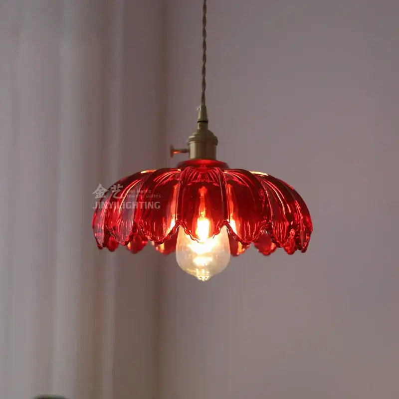 A vibrant red petal-shaped glass industrial pendant light with brass fixture and exposed bulb for dining room decorbites glass industrial