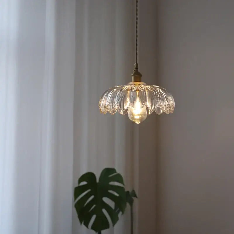 Industrial green petal glass pendant light with brass hardware featuring a delicate clear glass design for dining room decorbites glass industrial style