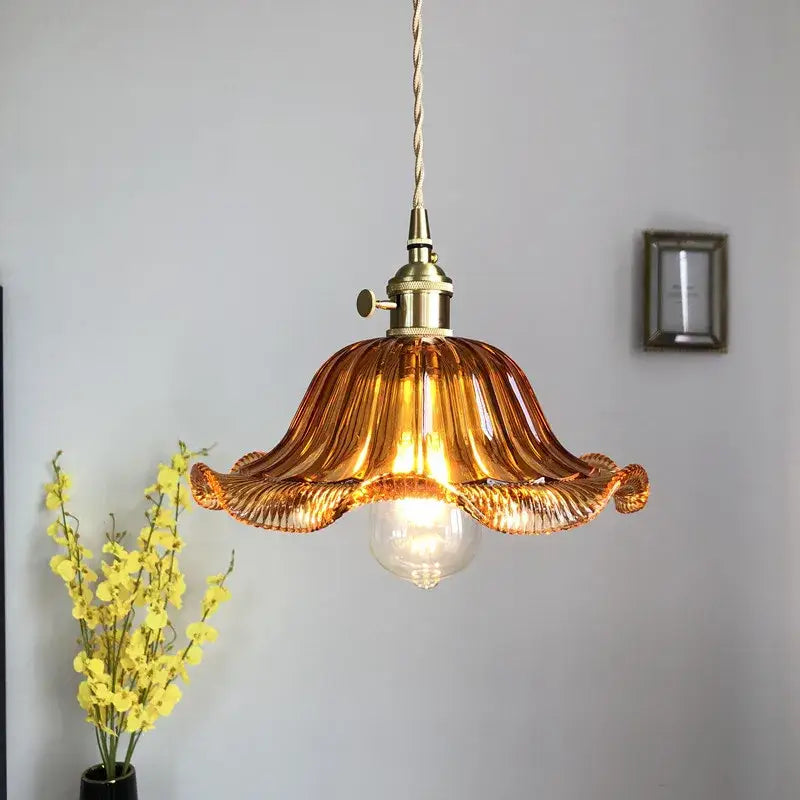 A warm amber glass industrial pendant light with fluted petal design and brass hardware for dining room decorbites glass industrial