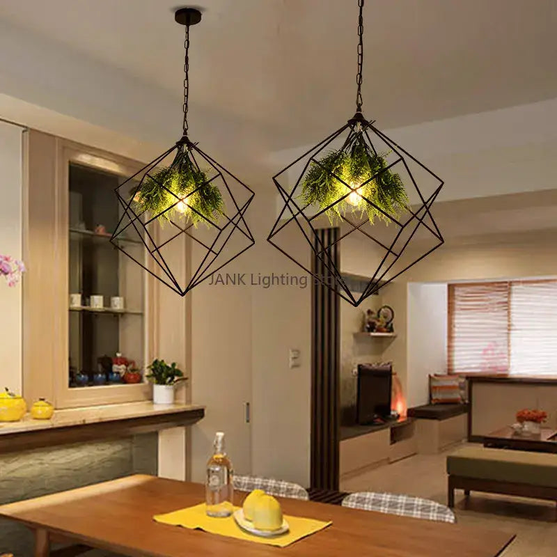 Black metal industrial greenery chandelier with geometric pendant lights and greenery suspended by chains decorbites industrial greenery