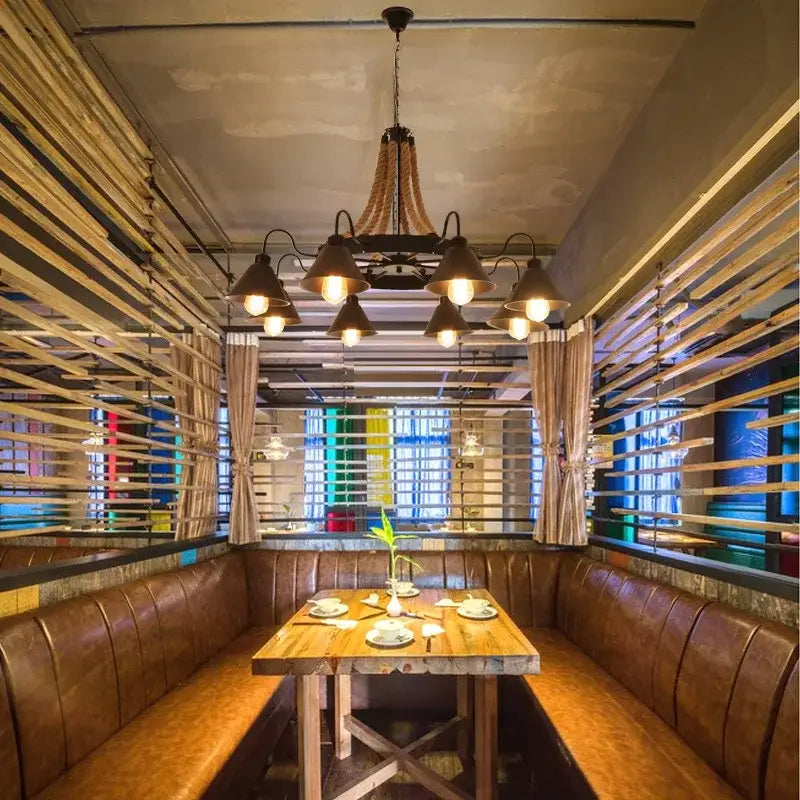 Industrial hemp rope pendant light with iron lampshade above rustic wooden table and brown leather booth seating decorbites industrial hemp