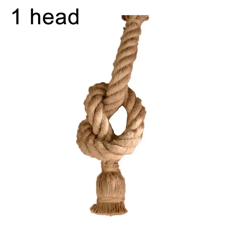 A rustic beige braided hemp rope pendant light knot with a frayed tassel for industrial dining room decorbites decor