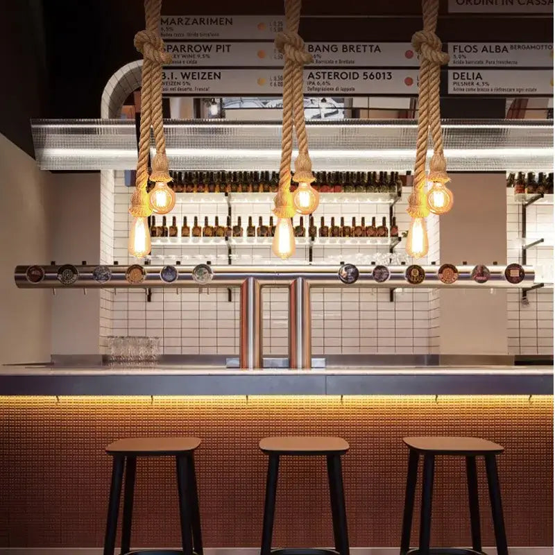 Thick natural-fiber hemp rope pendant light with warm edison bulbs above modern bar for dining room decorbites hemp rope chandelier