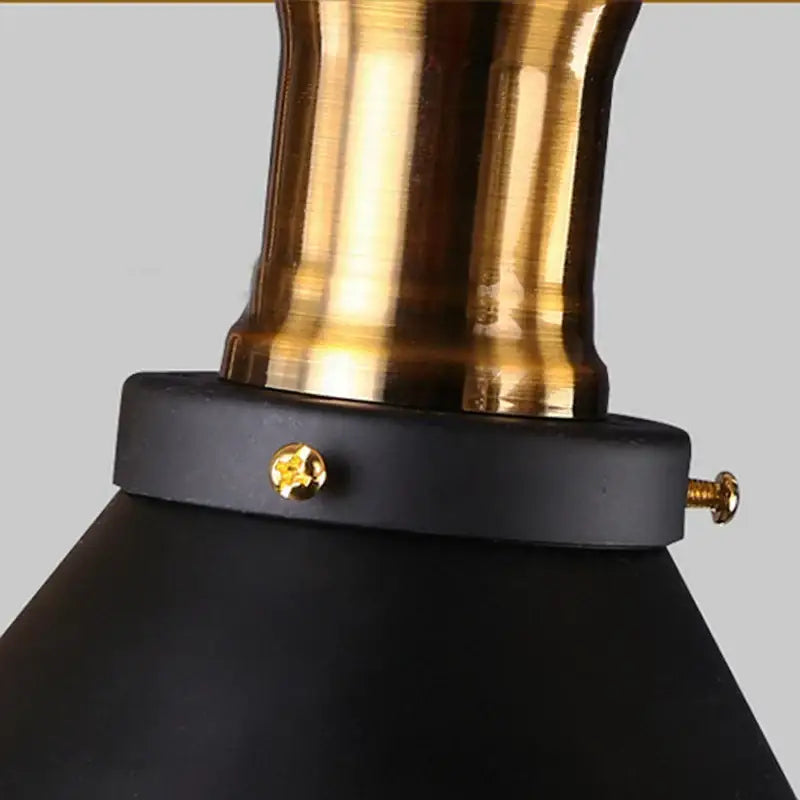 A sleek black matte pendant light with polished brass stem and gold screws for decorbites industrial hemp rope lighting