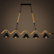 Industrial hemp rope pendant light with four black shades suspended by beige rope and metal chains for kitchen decor