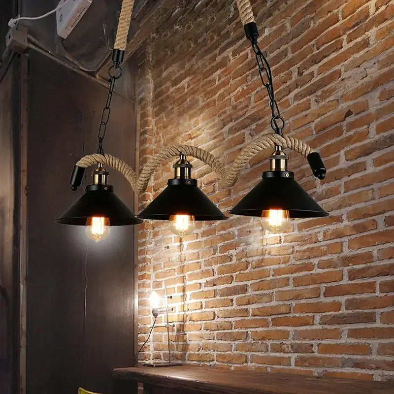 Industrial hemp rope pendant light with three black metal shades brass accents and thick rope suspension for decorbites industrial hemp collection