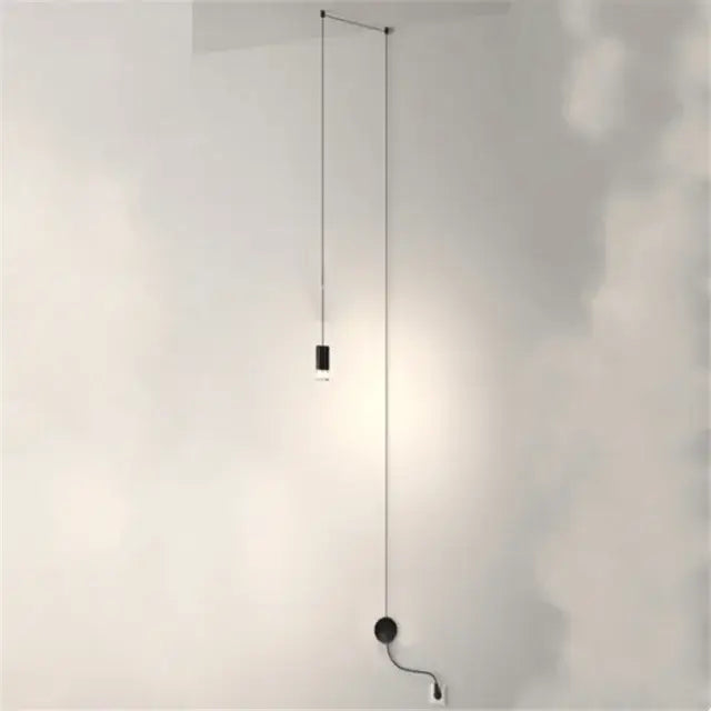 Minimalist black geometric pendant light with cylindrical bulb and thin cord in decorbites industrial iron art style