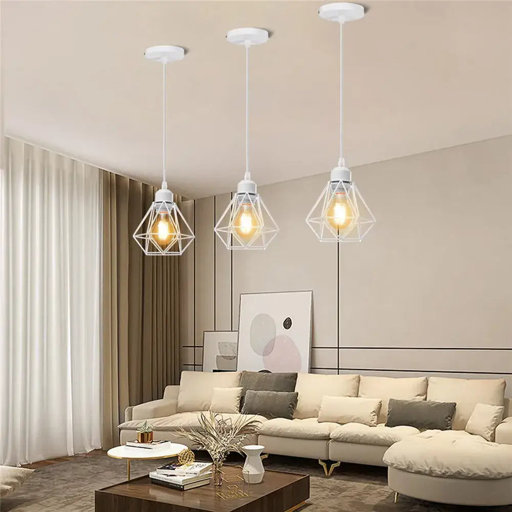 Three white geometric pendant lamps with iron cage and exposed filament bulbs for kitchen dining decorbites industrial iron