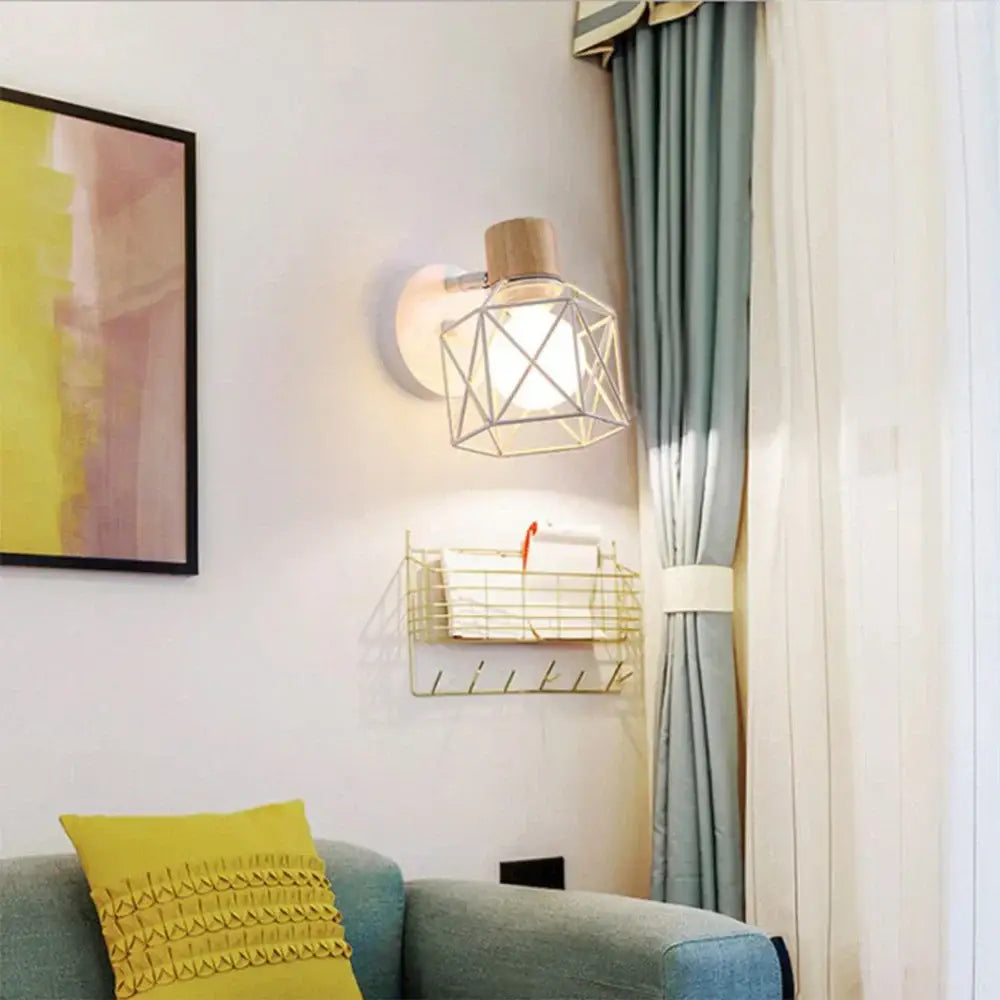 Industrial iron cage wall light with a geometric wireframe, wooden top, and frosted glass shade by decorbites iron cage