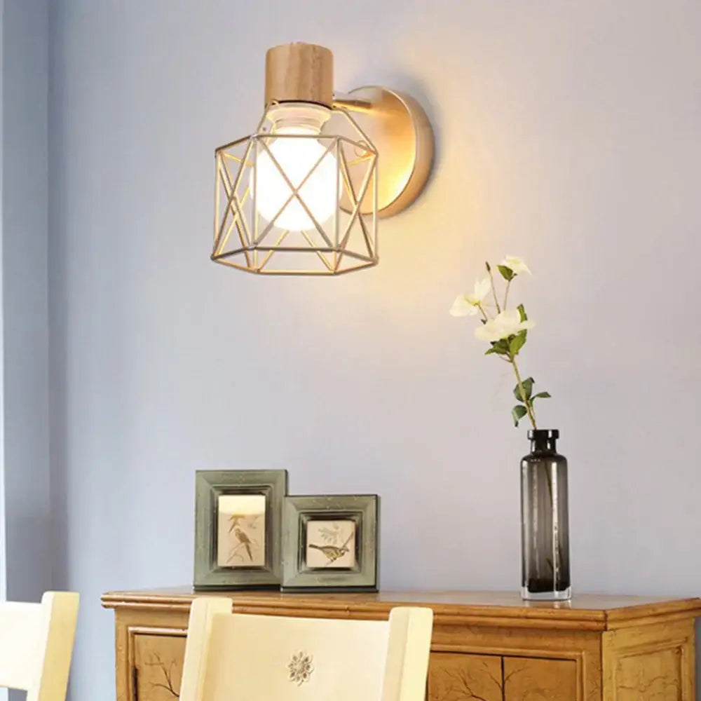 Industrial iron cage wall light with geometric gold-toned metal sconce, wooden top, and clear glass bulb by decorbites iron cage