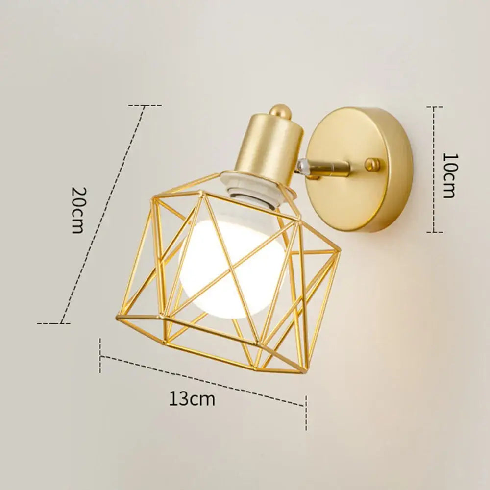 Gold-toned iron cage wall light with faceted design and frosted glass bulb for decorbites iron cage bedroom sconce