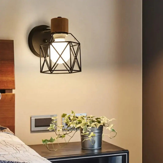 Industrial iron cage wall light with black metal geometric cage wooden top cap and exposed bulb decorbites iron cage