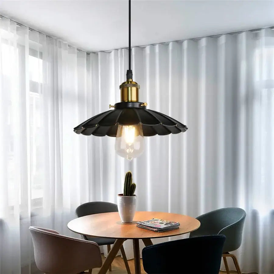 Black metal pendant light with brass finish top and fluted shade featuring exposed bulb for iron dome industrial decorbites use