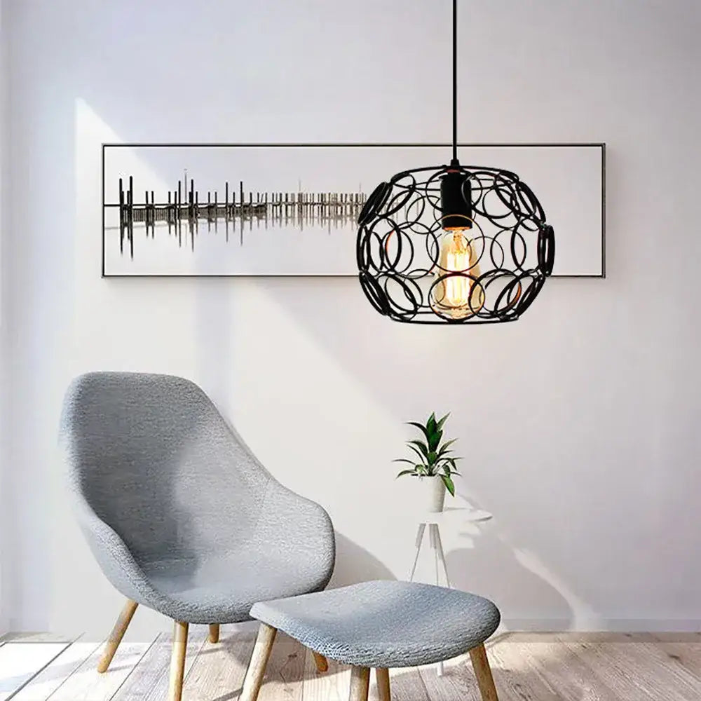 Black metal industrial iron pendant light with interlocking rings and exposed filament bulb for dining room decorbites industrial iron pendant