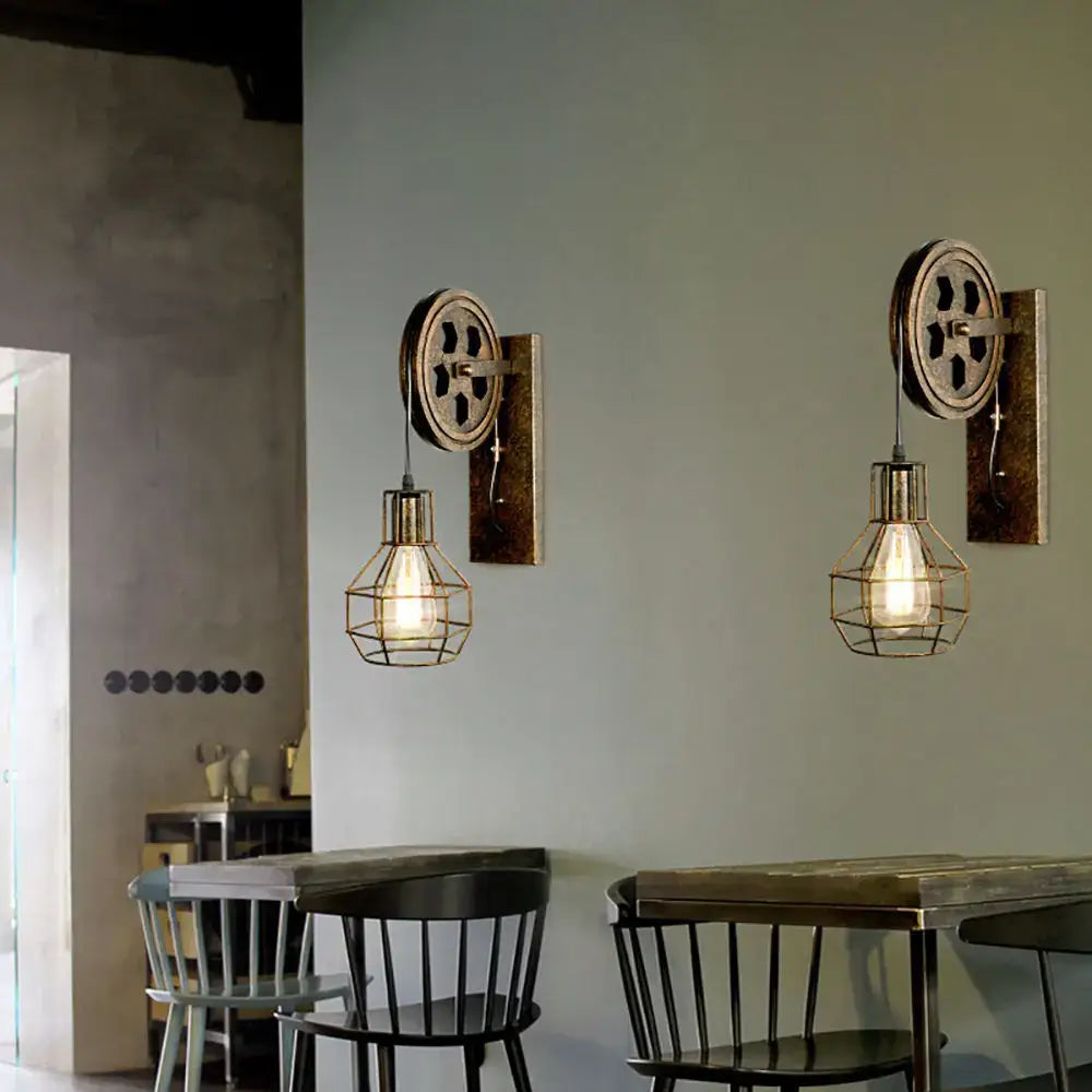 Industrial iron wall sconce with brass gear backplate wire cage and wooden pulley for cafe decorbites industrial iron decor