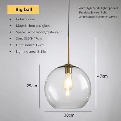 A clear glass globe pendant light with brass-finished iron art fixture and exposed bulb by decorbites industrial loft