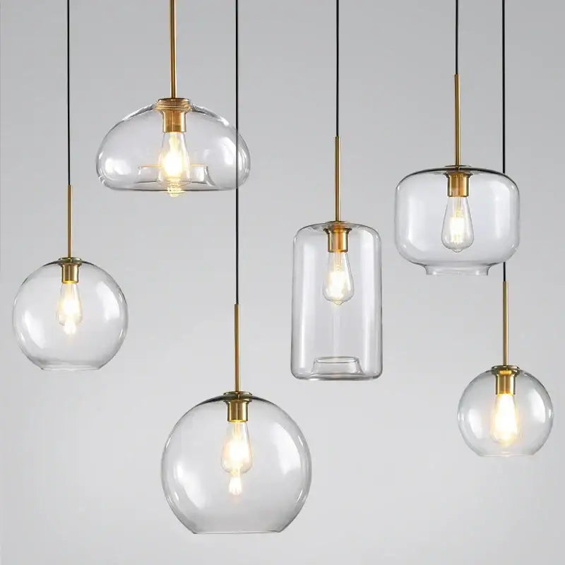 Industrial loft glass pendant light trio with clear glass, brass accents, and exposed filament bulbs for dining room decorbites industrial loft