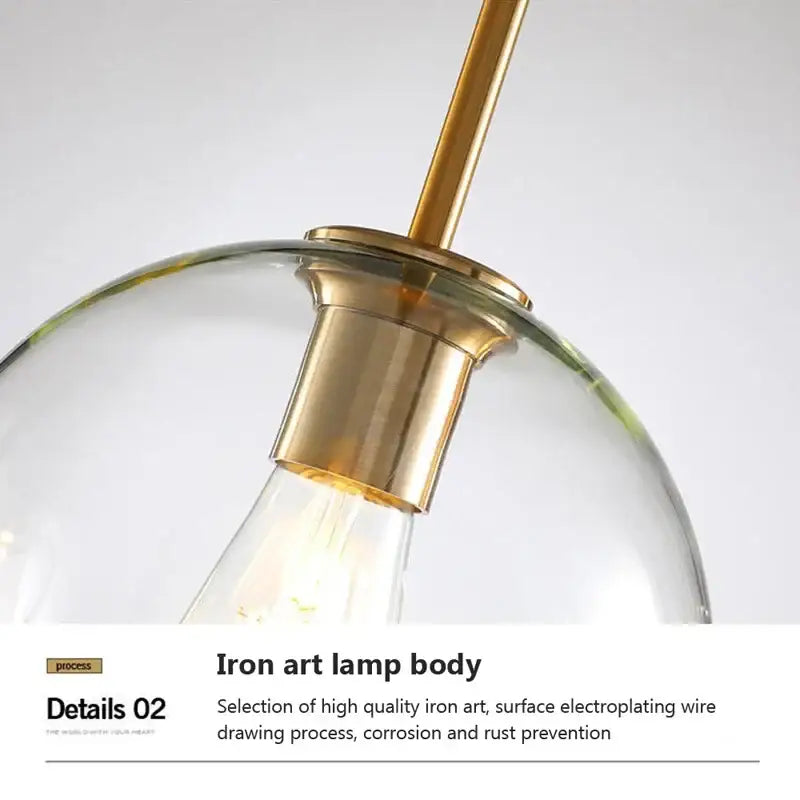 A modern industrial loft glass pendant light with clear glass dome and brass finished iron art body for dining room decorbites