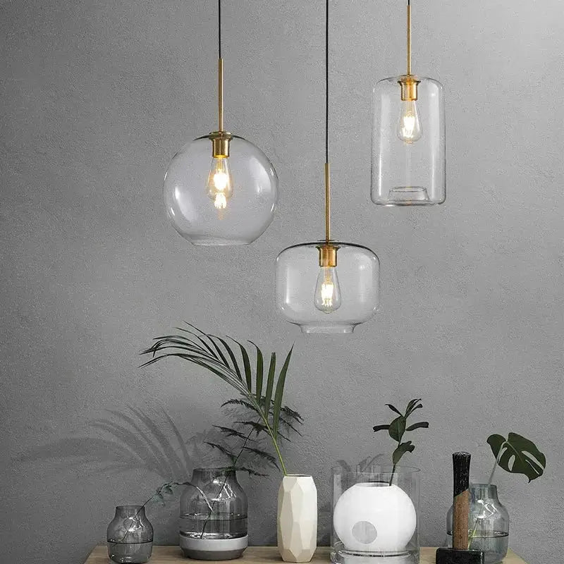 Three industrial loft glass pendant lights with brass accents and clear or frosted shades for dining room decorbites industrial loft