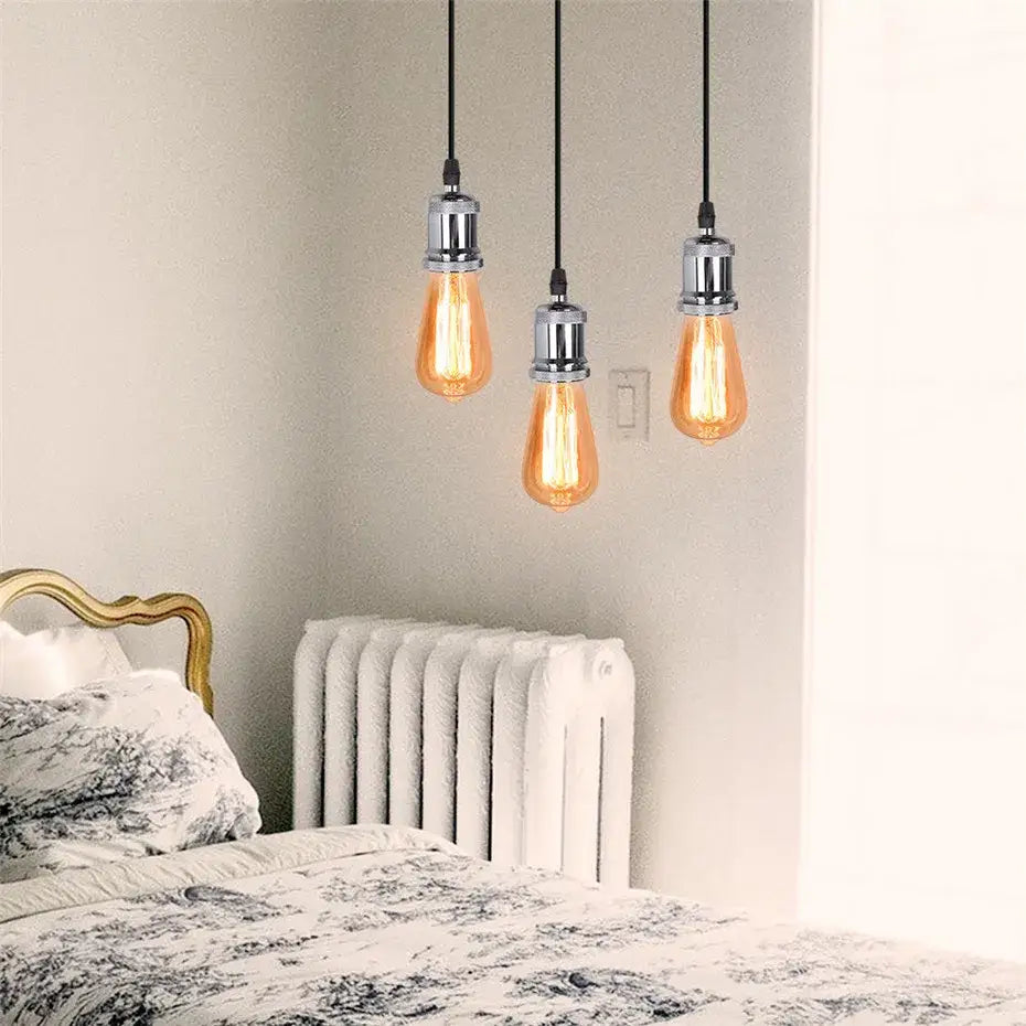 Three hanging vintage-style edison pendant light with warm amber glass and chrome fixtures for decorbites industrial loft