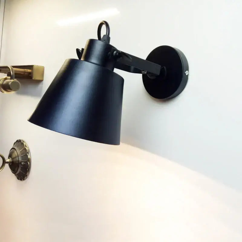 Black matte-finished industrial wall light with conical shade and adjustable arm decorbites adjustable edison wall light