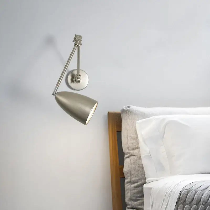 A sleek industrial matte black wall lamp with decorbites adjustable swing long arm and brushed metallic finish for bedroom decor