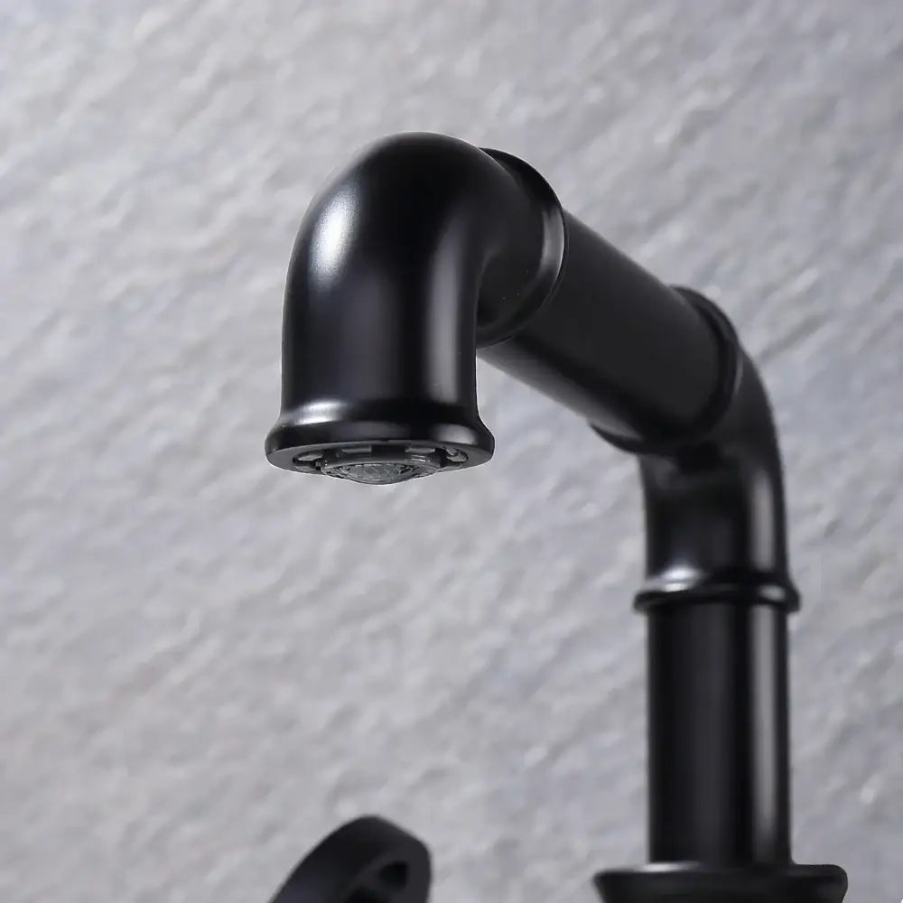 Industrial matte black brass bathroom faucet with curved spout and visible pipe joints for decorbites black brass decor