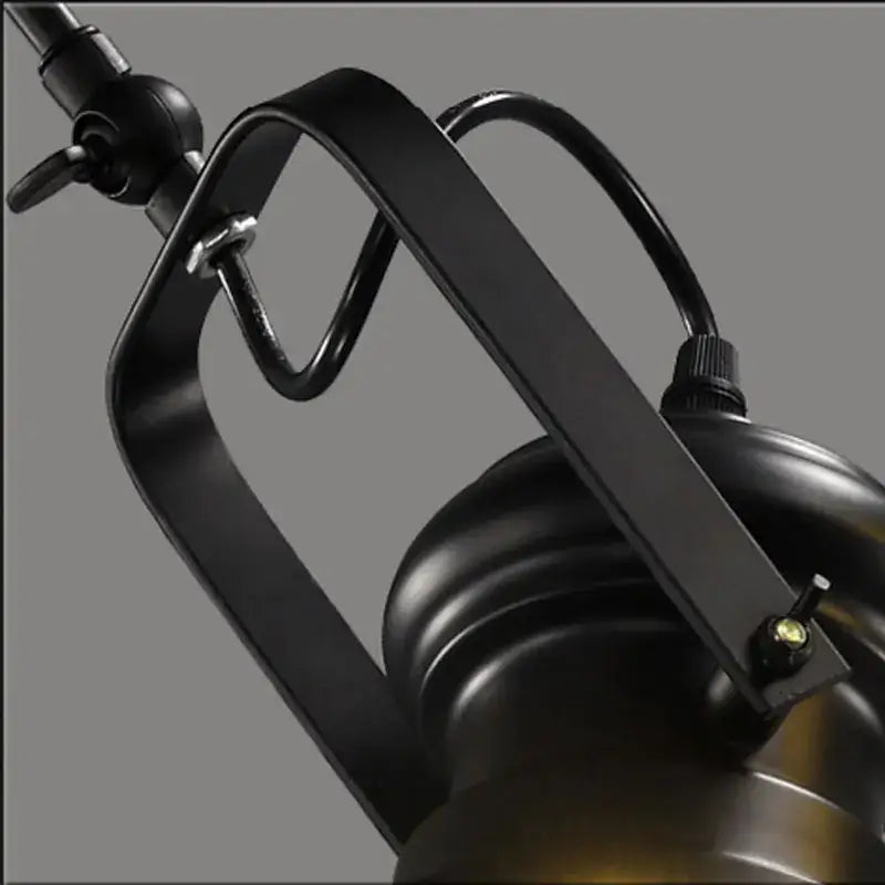 Black metal industrial-style desk lamp with matte finish and curved arm complementing decorbites retro dome pendant chandelier