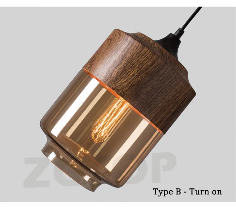 Warm-toned glass led pendant light with dark wood top and exposed Edison bulb for dining room light source