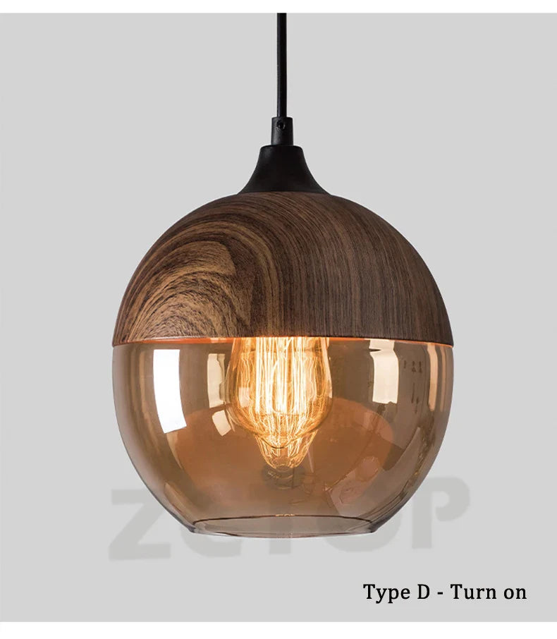Warm-toned led pendant light with dark wood top and glass shade featuring exposed filament bulb for dining room use