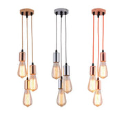 Three modern industrial rose gold and chrome led pendant lamps with exposed filament bulbs for dining room lighting