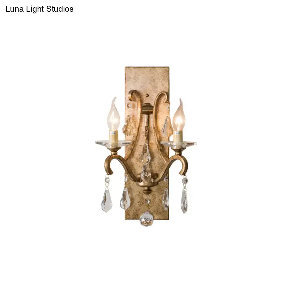 Antique gold-finished industrial rust iron wall sconce with e12 candle light and crystal teardrop pendants for bedroom