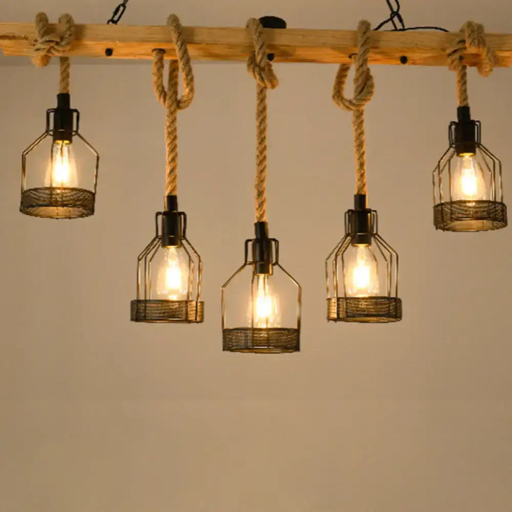 Industrial rustic hemp rope chandelier with five wire cage lamps suspended by thick hemp rope from wooden beam for dining room