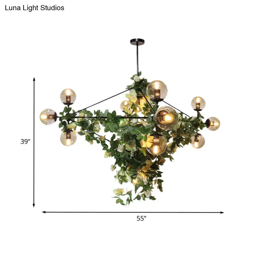 DecorBites™ industrial globe island pendant with smoke gray glass globes, black metal frame, and green vine accents