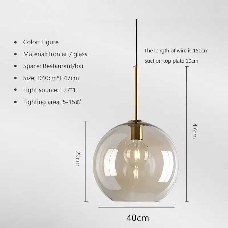 A modern industrial glass pendant light with amber-tinted globe and brass rod for dining room decorbites industrial glass