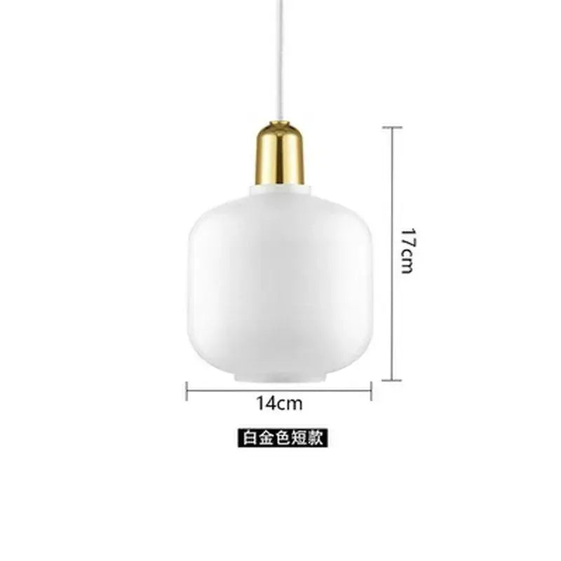 A sleek white frosted glass pendant light with polished gold metal fixture from decorbites industrial stained glass set